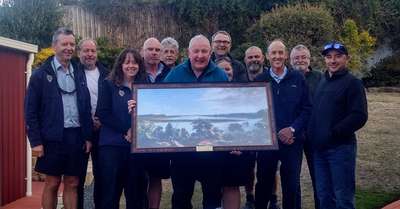 The staff of IFS presenting Stephen Hepworth with his retirement gift being a painting of yingina/Great Lake